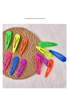 Flat lay of colorful 7cm neon drip oil water-drop hair clips on a textured background