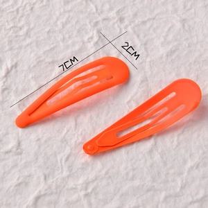 Neon orange 7cm matte lacquer water drop hair clips for girls on textured paper
