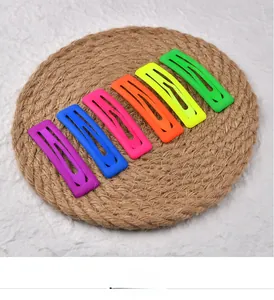 Close-up of 6-piece colorful square matte hair clips on a woven coaster