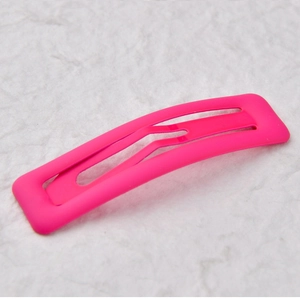Detail view of the neon pink matte metal hair clip with 7cm rectangular frame design