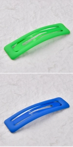 Close-up of matte square snap hair clips in neon green and royal blue finish