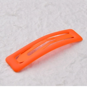 Macro detail of 7cm orange matte rectangular BB hair clip with smooth lacquer finish