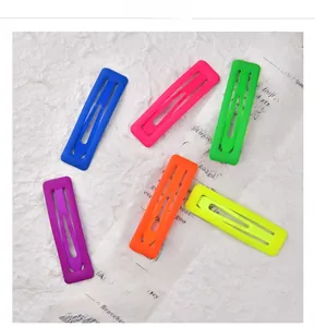 Detailed close-up of six vibrant matte finish rectangular hair clips in assorted neon colors