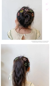 Detail showing colorful matte star hair clips on a girl's ponytail and bun