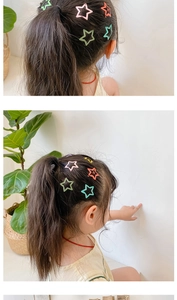 Close-up of matte star hair clips in macaron colors for children on simple background