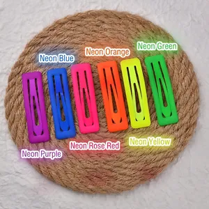 Set of 6 neon rectangle hair clips in vibrant matte colors on a woven mat