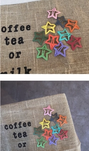 Close-up of colorful star-shaped hair clips in various macaron matte finishes