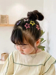 Cute matte star hair clips set in candy colors for kids worn by a young girl