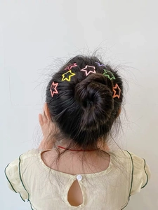 Star hair clips set for girls in various candy colors shown on a hairstyle