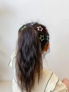 Star-shaped matte candy color hair clips for kids shown on a ponytail hairstyle