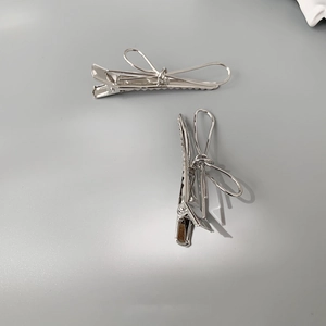 Set of two minimalist silver metal bow hair clips with elegant duckbill design