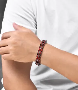 Detail of red and black bike chain style punk bracelet on male model wrist