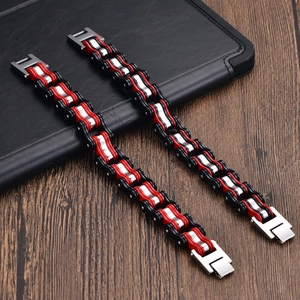 Close-up of bicycle chain style stainless steel bracelets with red and black link details