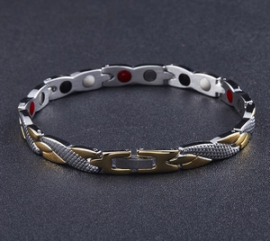 Detail of two-tone gold and silver magnetic therapy bracelet with inset mineral stones