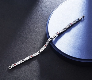 Macro view of magnetic therapy links with colorful inlay stones on a steel bracelet