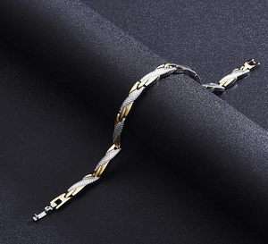 Detail of two-tone twisted link bracelet with gold and silver diamond-cut texture