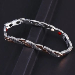 Detail of stainless steel magnetic therapy bracelet showing dual-tone links and mesh texture