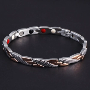 Macro detail of bicolored magnetic therapy bracelet with snake scale texture and inlay