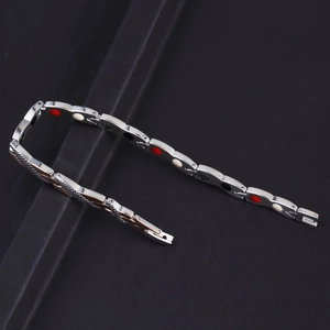 Detail of men's stainless steel magnetic therapy bracelet with snake scale texture and inlay
