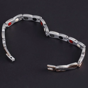 Macro detail of men's stainless steel magnetic energy bracelet with rose gold scales