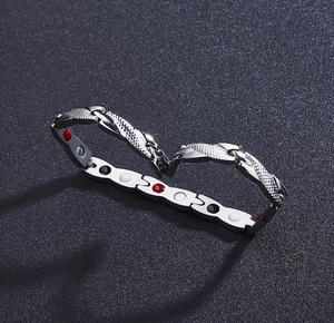 Close-up of magnetic energy bracelet with steel scales and colorful healing stones