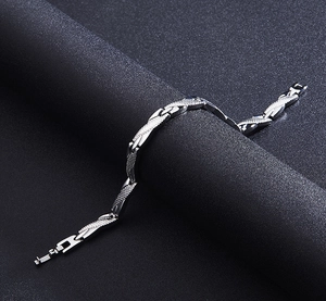 Detailed macro view of silver steel bracelet links with textured grid and polished finish