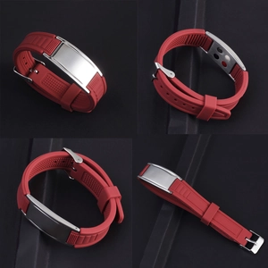 Detail view of red silicone sports bracelet with stainless steel plate and energy stones