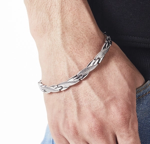 Detail of men's stainless steel bracelet with snake texture and polished metal links