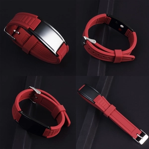 Detailed close-up of red silicone wristband with polished metal plate and adjustable buckle