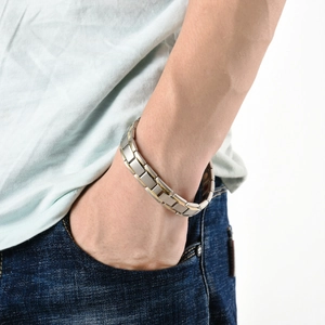 Close-up of men's two-tone silver and gold stainless steel link bracelet on wrist