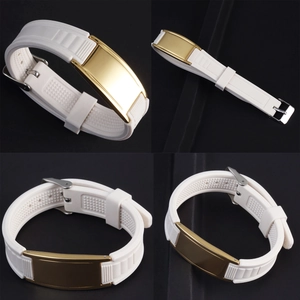 Detail showing adjustable white silicone strap and gold metal plate of sport bracelet