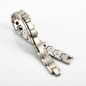 Detail of 12mm stainless steel magnetic therapy bracelet with gold edges and color inlays