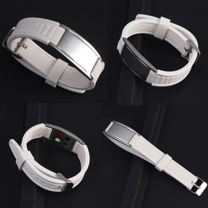 Macro detail of white silicone wristband with polished stainless steel clasp and magnetic stones