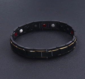 Detail view of black magnetic therapy bracelet with gold edges and inner health magnets