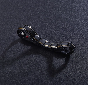 Detail of 12mm magnetic therapy bracelet with gold edges and red-white functional stones