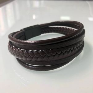 Men's multi-layer braided leather bracelet with dark brown cords and black magnetic clasp