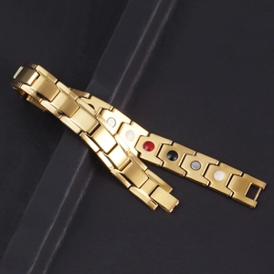 Macro detail of golden stainless steel magnetic therapy bracelet with four-color stones
