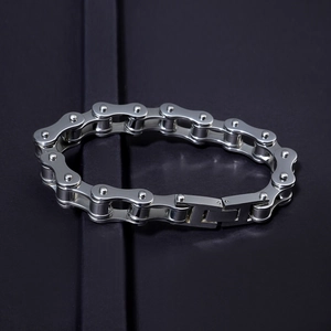 Polished titanium steel men's bracelet with industrial motorcycle chain design on dark background