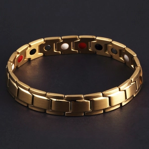 Close-up of golden titanium steel magnetic bracelet with multicolor inlay stones