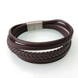 Detail view of multi-layer dark brown leather bracelet with woven cord and magnetic clasp