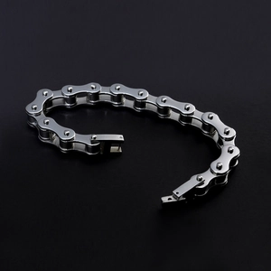 Detailed close-up of a silver titanium steel motorcycle chain bracelet with mirror finish