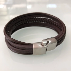 Detail of dark brown multi-layer leather bracelet with silver magnetic brushed metal clasp