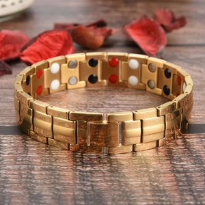Detail of gold magnetic therapy bracelet with inset energy stones on wooden background