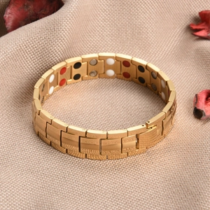 Detail of gold stainless steel link bracelet with magnetic energy stones and folding clasp