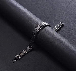 Detailed macro view of matte black stainless steel chain links with polished edges