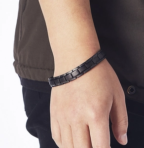 Close-up of men's matte black stainless steel curb chain bracelet on wrist