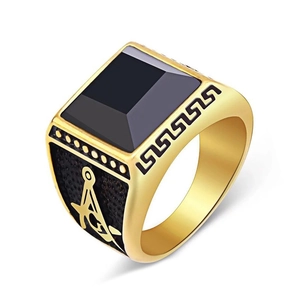 Detail view of gold signet ring with black stone inlay and Masonic side carvings