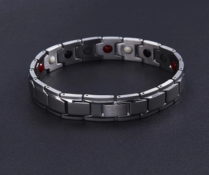 Detailed macro view of gunmetal magnetic stainless steel bracelet with therapy stones