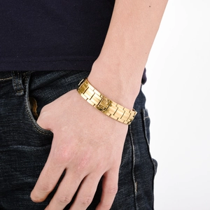 Polished gold double-row magnetic stainless steel bracelet shown on a male wrist