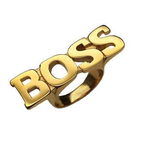 Macro shot of gold-plated stainless steel ring featuring a cutout BOSS logo design